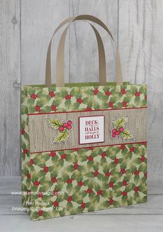 a green bag with holly leaves on it