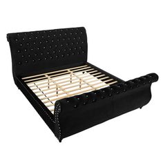 a black bed frame with studded headboard and foot board