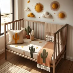 a baby's crib with cactus decorations on the wall