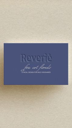 a business card with the words reverie on it