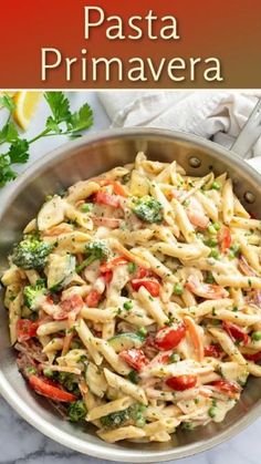 a pasta dish in a pan with broccoli and tomatoes