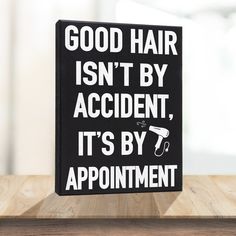 a sign that says good hair isn't by accident, it's by appointment