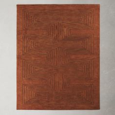 a brown area rug with an interlocked design on the top and bottom part