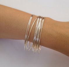 Welcome Dear Buyer, Dainty Thin 1.3mm Round, Sterling Silver Bangle Set, Set of 10 Bangles, Thin Stacking, Bangles, Silver Bracelet Set, Bangles     Handmade item     Ships from a small business in     India     Bracelet width: 15 Millimeters     Materials: Silver     Style: Boho & hippie     Can be personalized     Recycled Dainty Thin 1.3mm Round, Sterling Silver Bangle Set, Set of 10 Bangles, Thin Stacking, Bangles, Silver Bracelet Set, Bangles Silver Bangles Handmade Bangles Statement Bangles Stacking Bangles Fine Work Bangles KJ Jewellery Care Instructions :- -Avoid contact with all liquids and chemicals, such as perfume, sea water, mayonnaise, ammonia, chlorinated pool water, hair spray and sweat. -Remove your jewellery before going to bed. -Avoid direct sunlight, heat and cold, espe Stacking Silver Bracelets, Silver Bracelet Stack, Stacking Bangles, Bangles Silver, Bali Jewelry, Bracelet Set Silver, Sterling Silver Bangle, Jewelry Care Instructions, Handmade Bangles