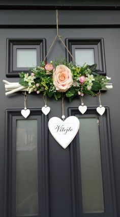 a door with flowers and hearts hanging from it's side, which says hope