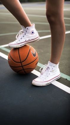 a person standing on top of a basketball