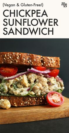 a sandwich with chicken, lettuce and tomatoes on it