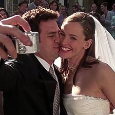 a bride and groom taking a selfie together