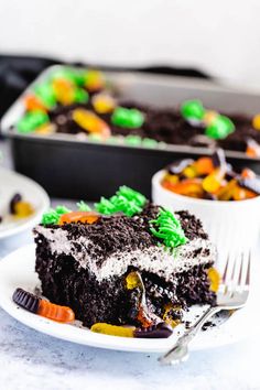 a slice of halloween cake on a plate with a fork in front of the cake