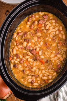 Get ready for a warm and cozy bowl of slow cooker ham and bean soup. This vibrant dish is packed with flavor and is perfect for chilly days. While the star ingredients are ham and beans, you’ll also find a medley of veggies, garlic, mushrooms, and aromatic herbs that elevate the taste. It’s an ideal way to use up any leftover ham or ham bones you might have, which is why many folks whip it up right after the holidays. Enjoy a hearty meal that feels like one big hug in a bowl. Slow Cooker Ham Bone Soup, Ham Hock Recipes Soup, Southern Ham And Beans Crockpot Recipes, Ham And Pinto Bean Soup Recipes, Soups With Ham Bone, Crockpot Beans And Ham, Beans And Ham Hocks Crockpot, Crockpot Bean Soup Recipes, Slow Cooker Ham And Bean Soup