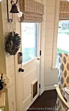 the front door is decorated with wreaths and decorations