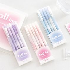 four pens are lined up on the table next to each other and packaged in plastic bags