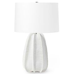 a white table lamp with a white shade on the base and a white fabric lampshade