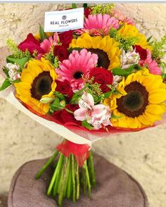 a bouquet of sunflowers and other flowers on display