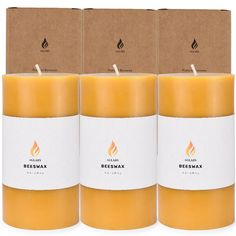 three beeswax candles are shown in front of the box and one is empty