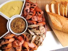 an assortment of breads and dips on a plate