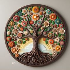 a tree with flowers and leaves painted on it's side in a circular frame