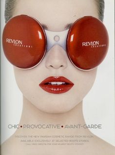 an advertisement for revlon cosmetics with the image of a woman's face and two round red glasses