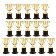 a bunch of golden trophies sitting on top of each other in front of a white background