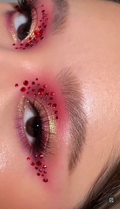 Gold Jewel Makeup, Sparkly Red Eye Makeup, Red Eye Makeup Gems, Red And Black Makeup Full Face, Red Makeup Rhinestones, Gold Concert Makeup, Red Jewels Makeup, Red Eye Makeup With Rhinestones, Prom Makeup Inspo Red