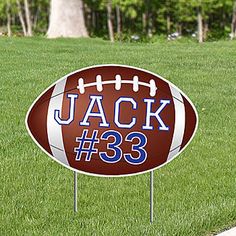 a football sitting on top of a lush green field next to a white line marker