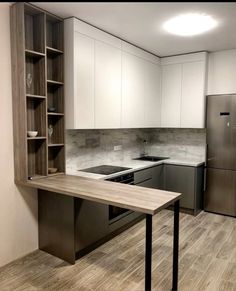 an empty kitchen with white cabinets and stainless steel appliances