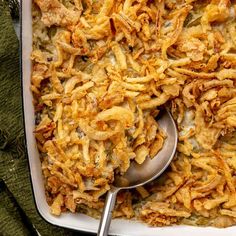 a casserole dish is shown with a spoon in it