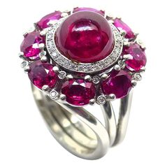 Thomas Leyser is renowned for his contemporary jewellery designs utilizing fine gemstones. This 950/ Platinum (22gr.) Ring with 1 Ruby Cabouchon in excellent quality, 9,5mm round, 6,00cts. + 8 Rubies in excellent quality, oval 5x4mm, 3,51cts. + 44 Diamonds, brillant cut, round 1mm, 0,32cts., D VS quality. This ring has a "spinning top". It can twist around. Just by tipping with the finger. The ringsize is 54 (6 3/4). Cabochon Ruby, Contemporary Jewelry Design, Vintage Cocktail Ring, Edwardian Jewelry, Tanzanite Diamond, Jewels Rings, Spinning Top, Expensive Jewelry, Ruby Jewelry