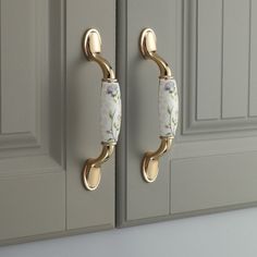 two gold handles with flowers painted on them are attached to the door knobs in this kitchen