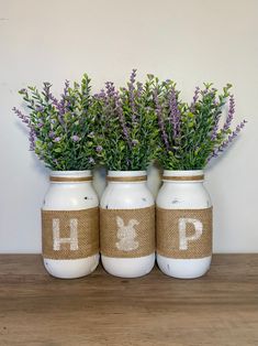 three mason jars with lavender flowers in them