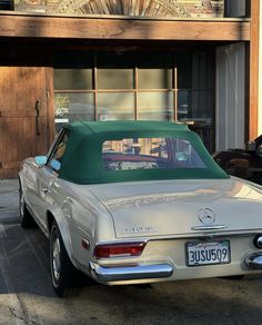 an old car parked in front of a building