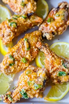 chicken wings with lemons and parsley on a plate