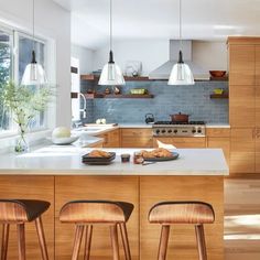 a kitchen with wooden cabinets and stools