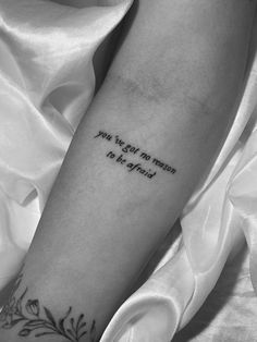 a person with a tattoo on their arm that says, you're the reason to be afraid