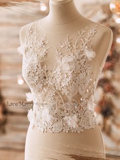 a mannequin with white flowers and lace on it