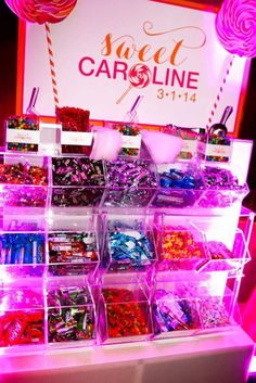 the candy bar is filled with lots of colorful candies and lollipops