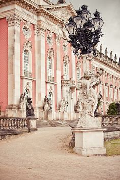 an old building with statues in front of it