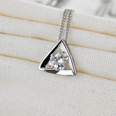 Trillion cut stone set in a triangle made of sterling silver. The stone measures 5 x 5mm White topaz are associated with love self esteem and good fortune. They are the birthstone for April. This elegant pendant is suitable to wear for daytime or evening wear. Finished with a commercial grade rhodium plate to give a high quality shine finish. Supplied in an Ojewellery presentation box, within a ribbon handled gift bag, complete with product information authenticity card with space for a gift message and a jewellery cleaning cloth to keep your jewellery in ready to wear condition. Our jewellery packaging is from an FSC chain of custody audited supplier and our very short supply chains mean we are able to trace our natural gemstones back to country of origin. Specification: Chain Curb Link 1 Trillion Cut Sterling Silver Jewelry Gift, Sterling Silver Pyramid Jewelry For Gifts, Sterling Silver Pyramid Jewelry As Gift, Pyramid-shaped Sterling Silver Jewelry Gifts, Formal Triangle Sterling Silver Jewelry, Triangle Shaped Sterling Silver Jewelry For Anniversary, Elegant Triangle Sterling Silver Jewelry, Elegant Sterling Silver Triangle Jewelry, Silver Triangle Jewelry Gift