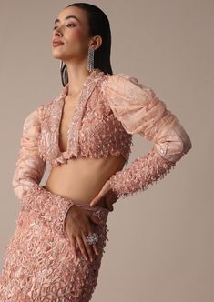 Slip into the epitome of elegance with our peach embroidered fish cut skirt set. A beautiful balance of grace and sophistication the short jacket is designed with intricate self zardosi embellishments. Flaunting a chic fish cut silhouette skirt and draped sleeves on the blouse the rich and opulent artistic embroidery creates a timeless appeal. Dry clean only if required. Slight variation in color is possible due to digital photography. Elegant Fitted Lehenga With Pearl Embroidery, Glamorous Long Sleeve Sets With Pearl Embroidery, Glamorous Long Sleeve Set With Pearl Embroidery, Elegant Semi-stitched Peach Lehenga, Elegant Semi-stitched Peach Choli, Elegant Peach Choli For Festive Season, Elegant Peach Choli For Reception, Elegant Festive Peach Choli, Elegant Designer Peach Lehenga