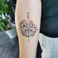 a person with a compass tattoo on their arm