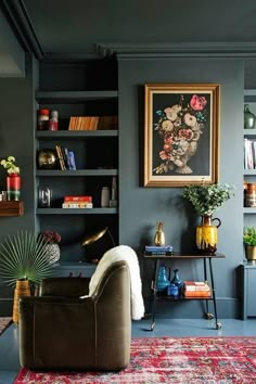 a living room with dark blue walls and lots of bookshelves on the shelves