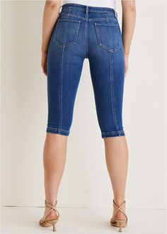 Now trending: capris! Jump on the trend with these modern jeans that flatter every figure. Hitting just below the knee, this capri style shows some leg without revealing too much. Seam details elongate your silhouette and add a fun flair to your denim collection.  * Available in plus size  * Zipper and button closure  * 17" inseam  * Cotton/viscose/spandex. Imported Stretch Cropped Jeans In Dark Wash, Stretch Cropped Leg Jeans In Dark Wash, Stretch Dark Wash Cropped Jeans, Trendy Dark Wash Knee-length Bottoms, Trendy Medium Wash Knee-length Bottoms, Fitted Knee-length Denim Jeans, Spring Mid-rise Capris, Trendy Denim Capri Jeans, Fitted Knee-length Jeans For Summer