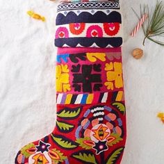 a colorful christmas stocking hanging from a tree