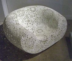 a large white bowl sitting on top of a black counter next to a wall and door