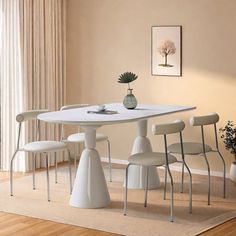 a white table with four chairs around it