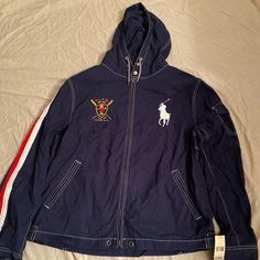 100% Cotton Navy Long Sleeve Windbreaker With Pockets, Navy Hooded Outerwear For Spring, Navy Casual Long Sleeve Outerwear, Casual Navy Long Sleeve Outerwear, Blue Cotton Hooded Jacket With Pockets, Navy Long Sleeve Windbreaker For Spring, Navy Casual Track Jacket With Pockets, Blue Cotton Long Sleeve Outerwear, Casual Blue Sport Coat For Spring