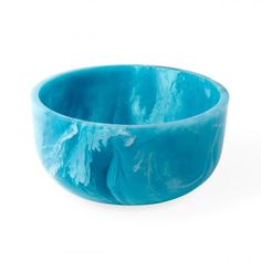 a blue bowl sitting on top of a white table