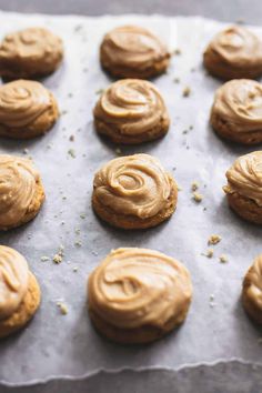 cookies with peanut butter frosting sitting on top of a baking sheet, ready to go into the oven