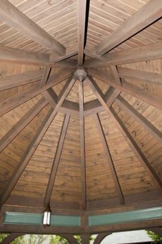 the inside of a wooden gazebo with glass doors