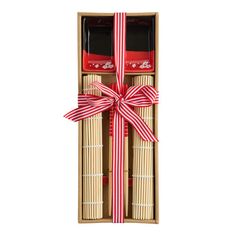 an open box with two red and white boxes in it, tied with a ribbon